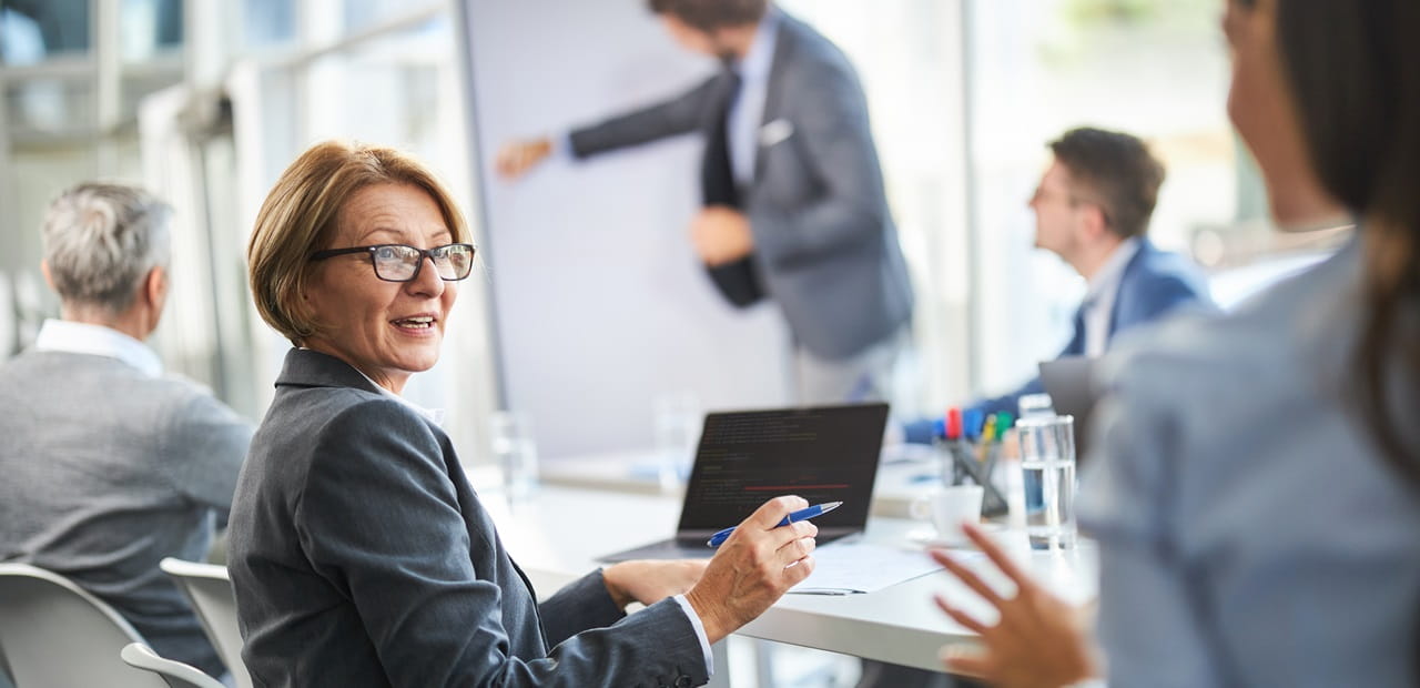 Senior businesswoman talking to her colleague in the office.