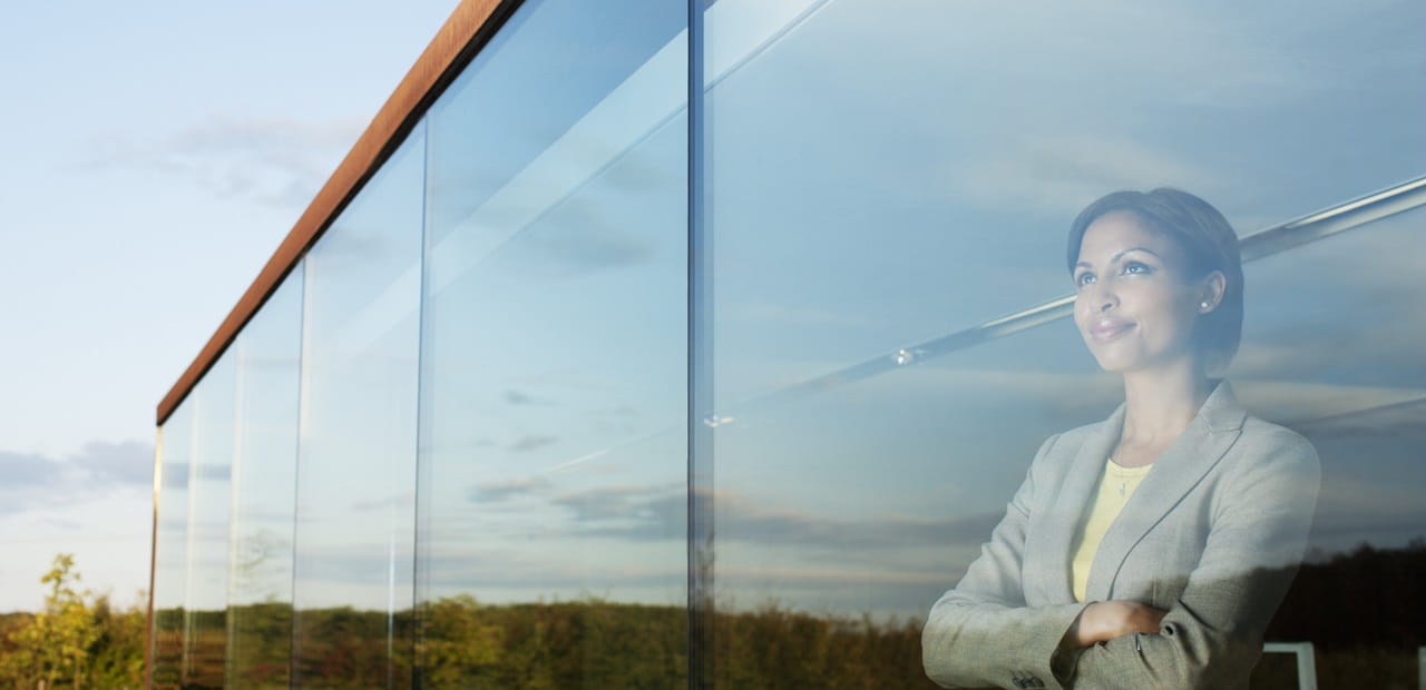 Businesswoman looking out office window.