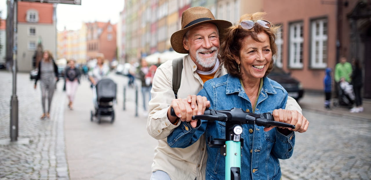   Overview Metadata Similar Portrait of happy senior couple tourists riding scooter together outdoors in town