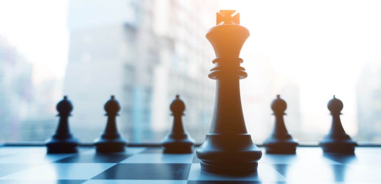 Chess pieces in front of an urban skyline